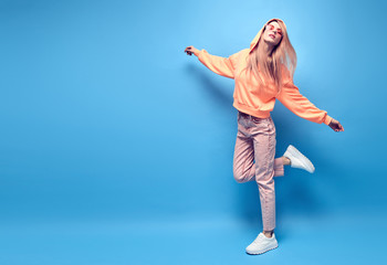 Young positive hipster Woman dance Having Fun, stylish fashion headphones. Beautiful excited...