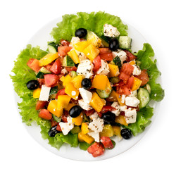 Plate with Greek salad on a white. The form of the top.