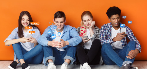 Bloggers with phones chatting in social networks, orange wall