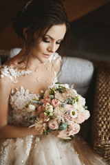 Stylish bouquet of pink and white flowers in the hands of the beautiful model girl in trendy...