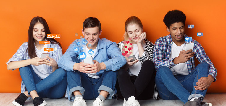 Bloggers with phones chatting in social networks, orange wall