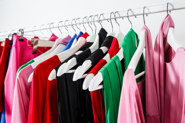 Fototapeta premium Cocktail dress. Clothing on hanger at the modern shop boutique. Bright multi-colored fabrics. concept of shopping.