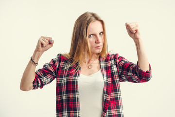 Portrait of a young displeased woman who is outraged. A woman shows negative emotions anger,...