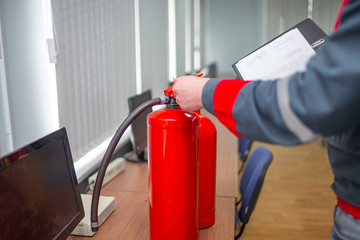 Engineer Professional are Checking A Fire Extinguisher Using Clipboard or checking Industrial fire control system,Fire Alarm controller, Fire notifier, Anti fire.System ready In the event of a fire.