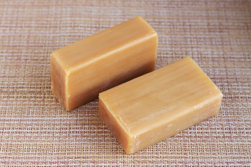 two pieces of brown soap on the table