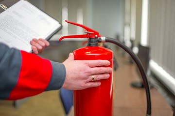 Engineer Professional are Checking A Fire Extinguisher Using Clipboard or checking Industrial fire control system,Fire Alarm controller, Fire notifier, Anti fire.System ready In the event of a fire.