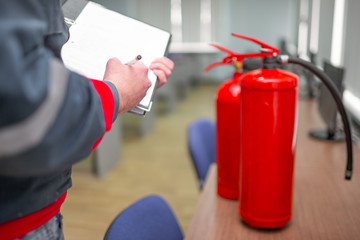 Engineer Professional are Checking A Fire Extinguisher Using Clipboard or checking Industrial fire control system,Fire Alarm controller, Fire notifier, Anti fire.System ready In the event of a fire.