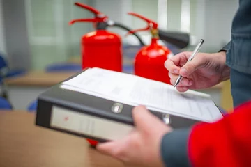Tuinposter Engineer Professional are Checking A Fire Extinguisher Using Clipboard or checking Industrial fire control system,Fire Alarm controller, Fire notifier, Anti fire.System ready In the event of a fire. © silentalex88