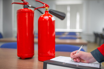 Engineer Professional are Checking A Fire Extinguisher Using Clipboard or checking Industrial fire...