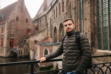 Fototapeta na wymiar Young man walking in Belgium, Brugge. Male tourist