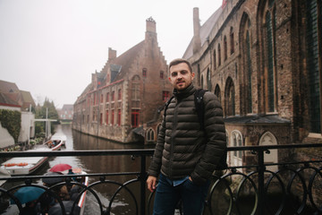 Young man walking in Belgium, Brugge. Male tourist