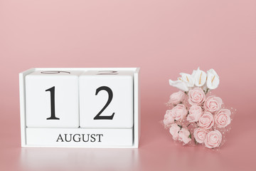August 12th. Day 12 of month. Calendar cube on modern pink background, concept of bussines and an importent event.