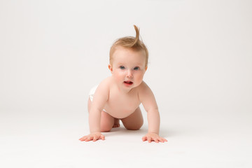 baby girl 6 months in diapers on white isolate background,6 months old baby girl, crawling happy smiling on a white background