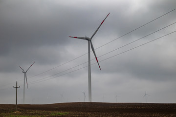 Wind generator turbine or windmill or wind farm, cloudy foggy day