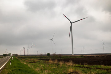 Wind generator turbine or windmill or wind farm, cloudy foggy day
