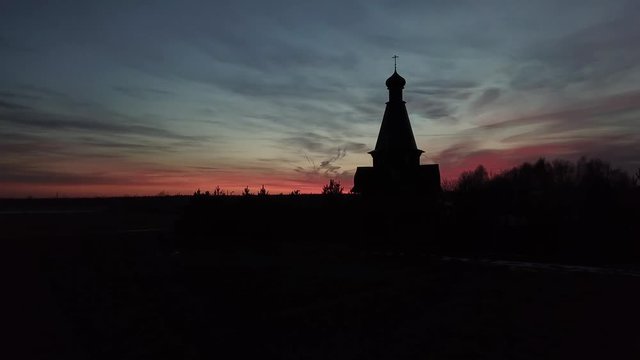 Silhouette of the temple in the name of the Icon of the Mother of God The Bogger of the microdistrict of the Lugovaya town of Lobnya, Moscow region. Sunset landscape
