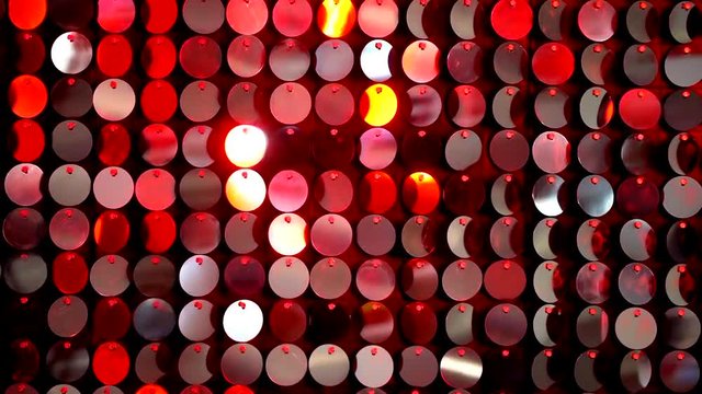 Red sequins sparkling reflective background. Abstract kinetic glitter wall moving. Night club decoration. Can be used as transitions, added to modern projects,art backgrounds.