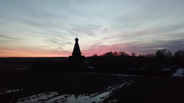 Silhouette of the temple in the name of the Icon of the Mother of God The Bogger of the microdistrict of the Lugovaya town of Lobnya, Moscow region. Sunset landscape