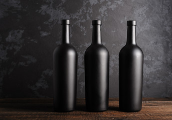 Fototapeta na wymiar Red wine bottle on a wooden background