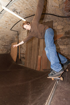 Young Man on Skateboard in a Half-Pipe