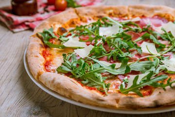 Pizza with Parma ham and arugula
