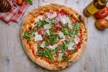 Pizza with Parma ham and arugula