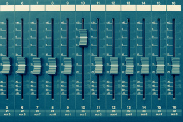 Sound mixer panel with feyder and buttons of control the top view with cyan toning