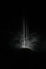 Traces of light in illuminated  waterdrops on cave calcite