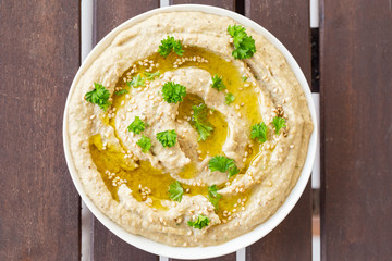 Vegan baba ghanoush, a levantine appetizer of mashed cooked eggplant mixed with tahini, olive oil,...