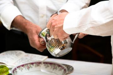 Two men washing hands at Passover. Jewish tradition