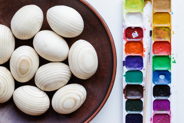 Clean eggs with paints on background