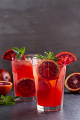 Blood orange cocktail with slices of citrus fruits and mint. room for text