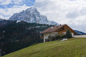 Fototapeta na wymiar Langkofel chalet, building, hut wolkenstein juac hut, regensburger hut mountain in the dolomites, giant rock, Sasso Piato in the Dolomites Alps, Italy