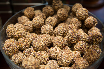Sweet balls, homemade healthy dessert with dried fruits, cocoa, sesame and nuts. 