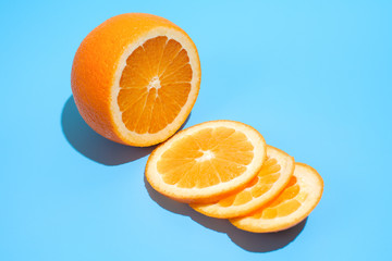 Ripe juicy delicious orange on blue background. Healthy eating and dieting concept