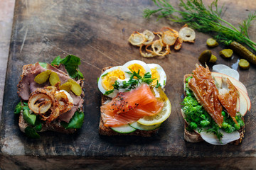 Scandinavian open sandwiches: beef, watercress and crisp onion, egg and salmon, smocked mackerel with crushed peas, fennel and apple