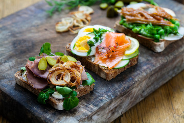 Scandinavian open sandwiches: beef, watercress and crisp onion, egg and salmon, smocked mackerel with crushed peas, fennel and apple