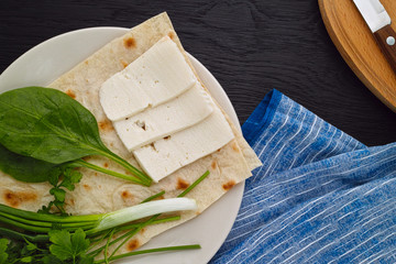 Goat cheese with pita bread and greens