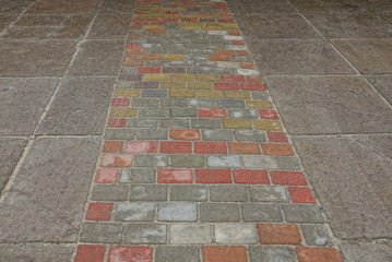 stone background of colored dirty paving bricks and concrete slabs on the road