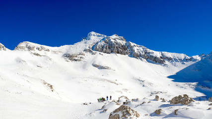 Fototapeta na wymiar Panoramic drone view of mountain's peak covered by snow