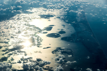 Top view of white clouds above water and islands