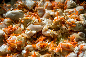 Cooking, sliced carrots and meat fried in a pan