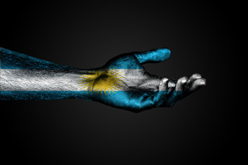 Outstretched hand with a drawn Argentina flag, a sign of help or a request, on a dark background