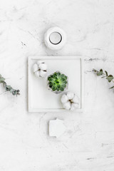 plant, candle, concrete figures and tray decorations for morden home office on marble background flat lay
