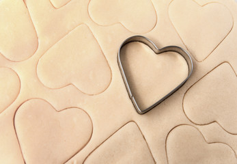 Obraz premium Dough for cookies. A mold for cutting cookies in the form of heart. St. Valentines Day. Top view