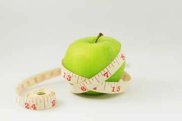 apple with measuring tape isolated on white