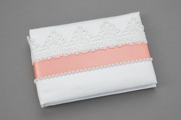 Decorated with lace and pearls wedding album on gray background.