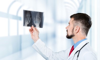 Young man doctor holding stethoscope