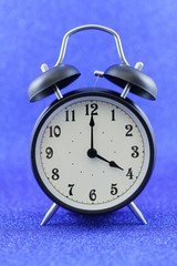 Alarm clock isolated on blue background