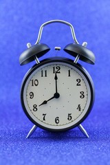 Alarm clock isolated on blue background